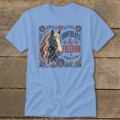 Blue t-shirt with a horse graphic featuring an American flag mane and text "Hoofbeats & Freedom Since 1776".