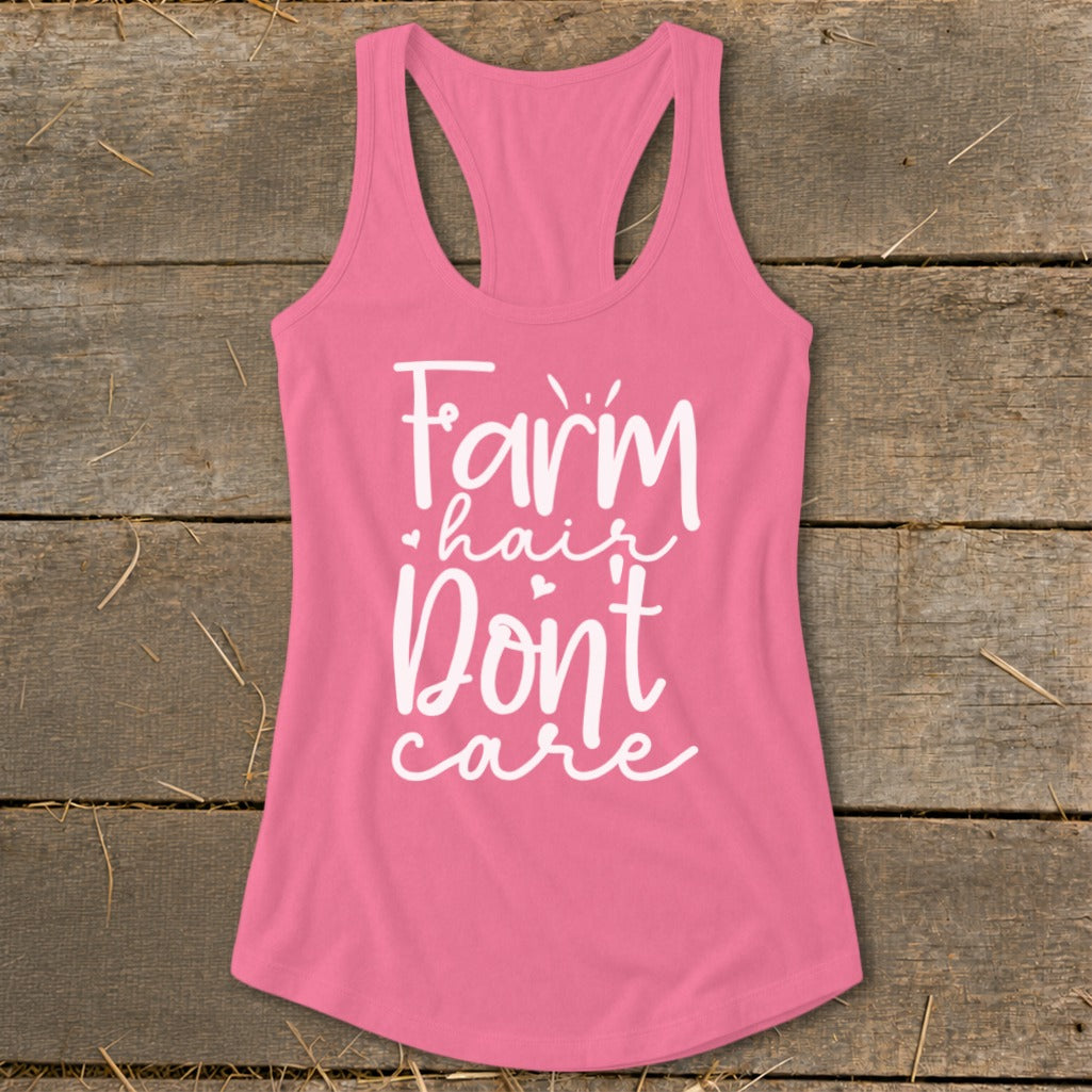 Pink racerback tank top with white text "Farm hair Don't care".