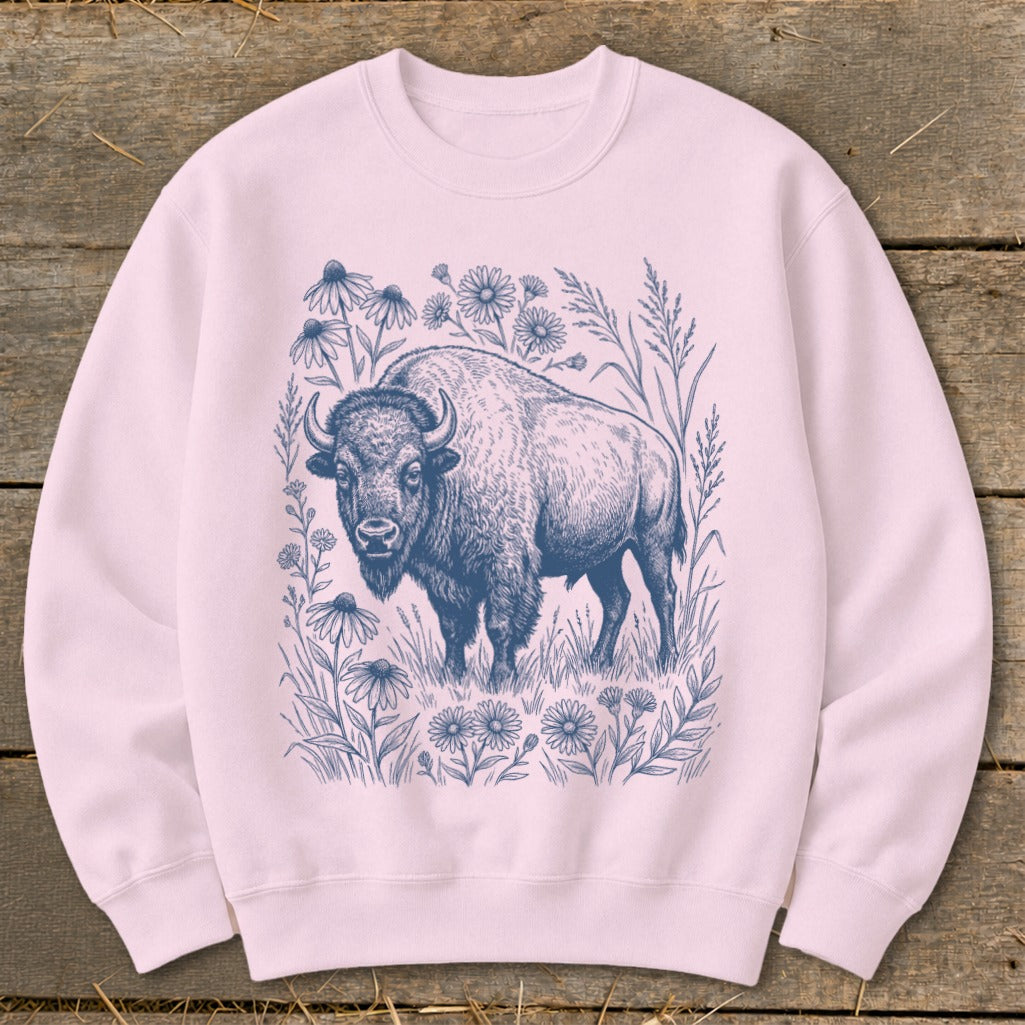 Pink sweatshirt with a blue line drawing of a bison surrounded by wildflowers.