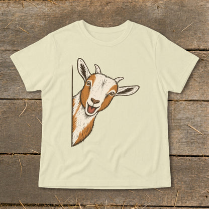 Illustration of a smiling goat peeking from the side on a light cream t-shirt.