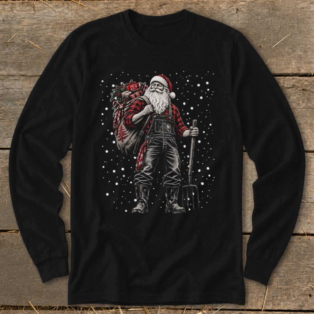 Farmer Santa with a sack of gifts and a pitchfork, standing in the snow.