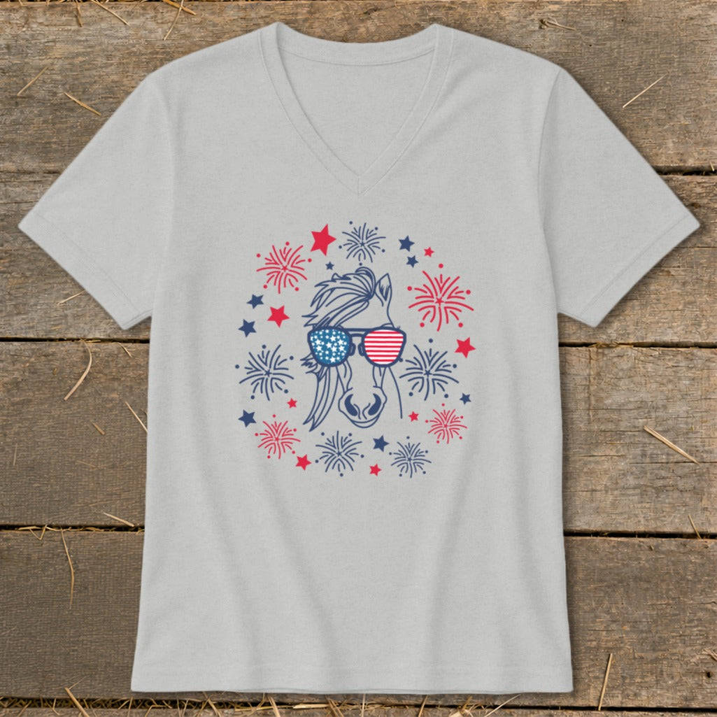 Horse with American flag sunglasses surrounded by fireworks on a grey v-neck t-shirt.