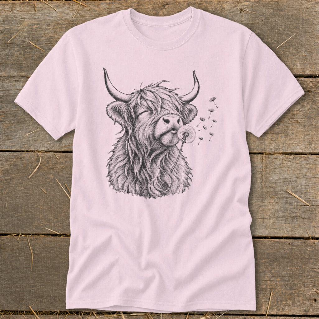 Highland cow with closed eyes blowing dandelion seeds on a pink t-shirt.