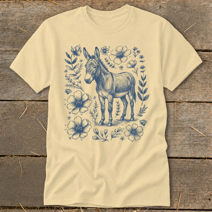 Light yellow t-shirt with a blue ink drawing of a donkey surrounded by flowers.