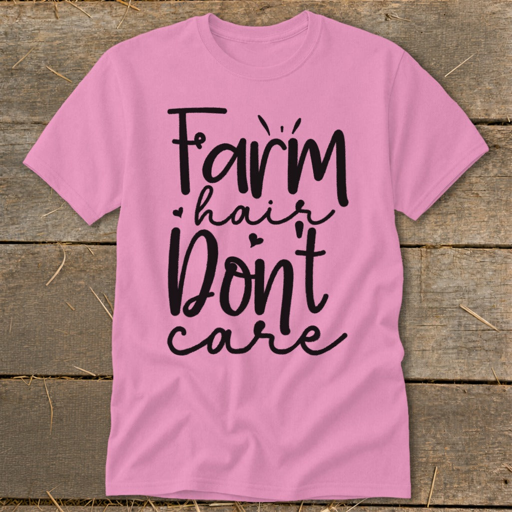 Pink t-shirt with black text reading "Farm hair don't care".