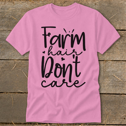 Pink t-shirt with black text reading "Farm hair don't care".