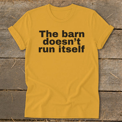 Yellow t-shirt with black text reading "The barn doesn't run itself".