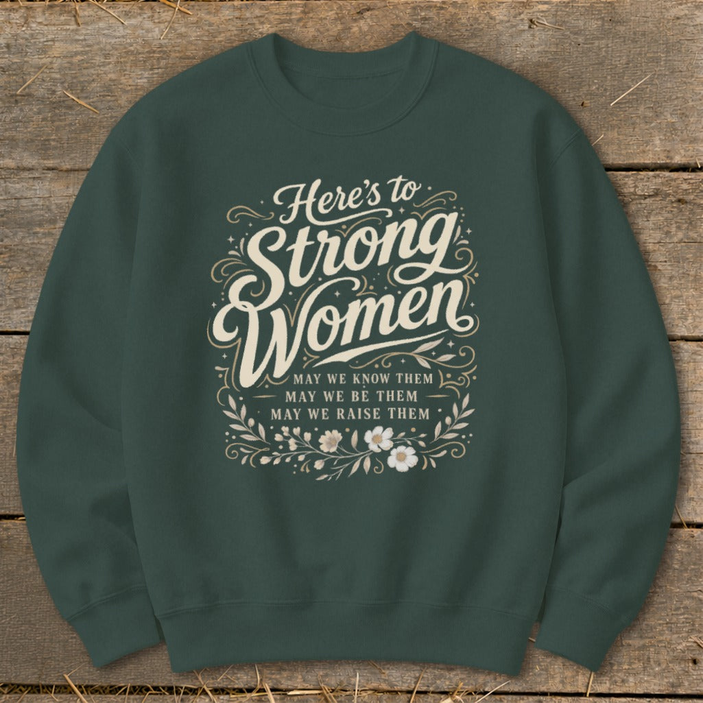 Dark green sweatshirt with "Here's to Strong Women" text and floral design.