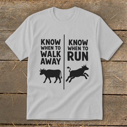 White t-shirt with black text and cow silhouettes: "Know when to walk away" and "Know when to run".