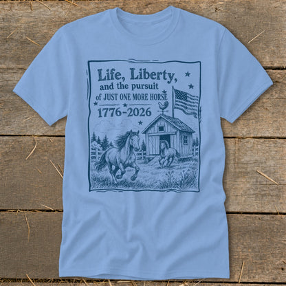 Light blue t-shirt with "Life, Liberty, and the pursuit of JUST ONE MORE HORSE 1776-2026" text and horse graphic.