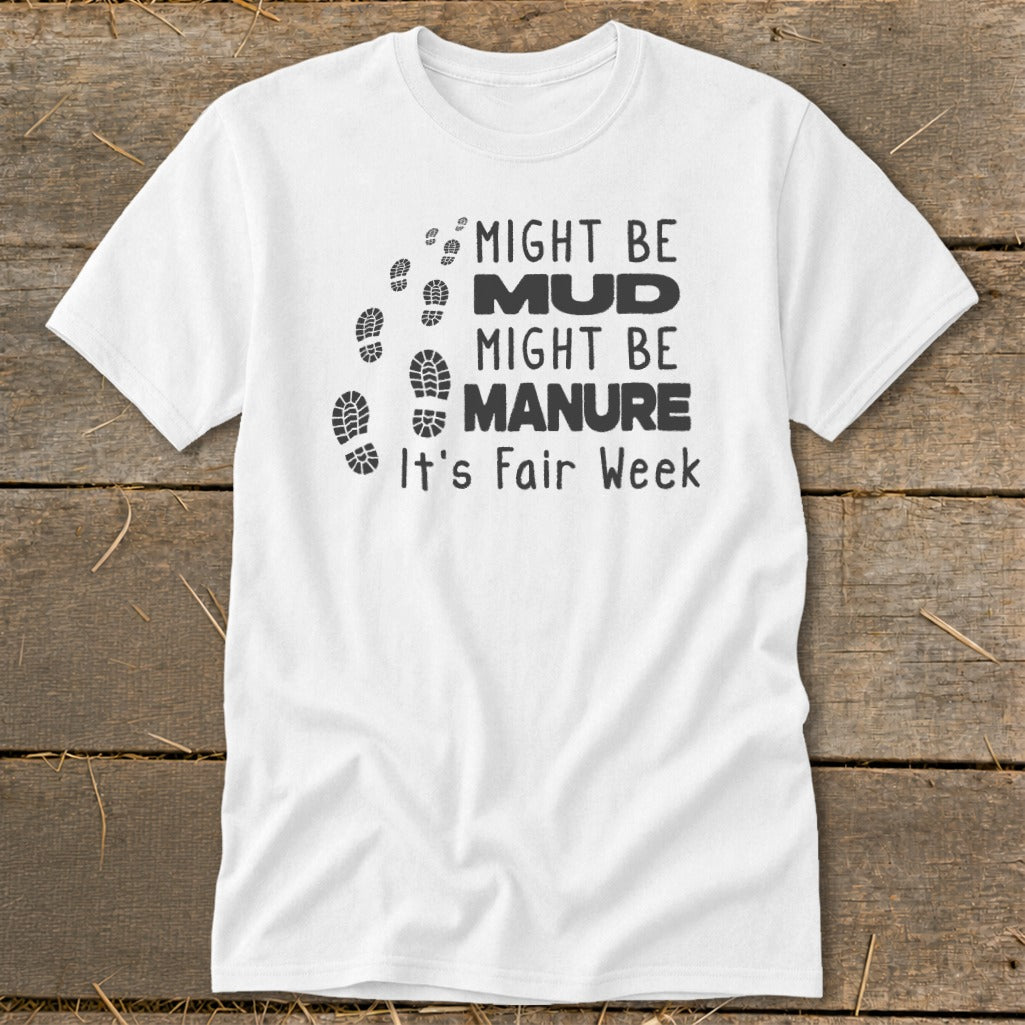White t-shirt with footprints and text: "Might Be Mud, Might Be Manure, It's Fair Week."