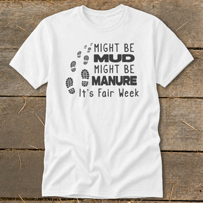 White t-shirt with footprints and text: "Might Be Mud, Might Be Manure, It's Fair Week."