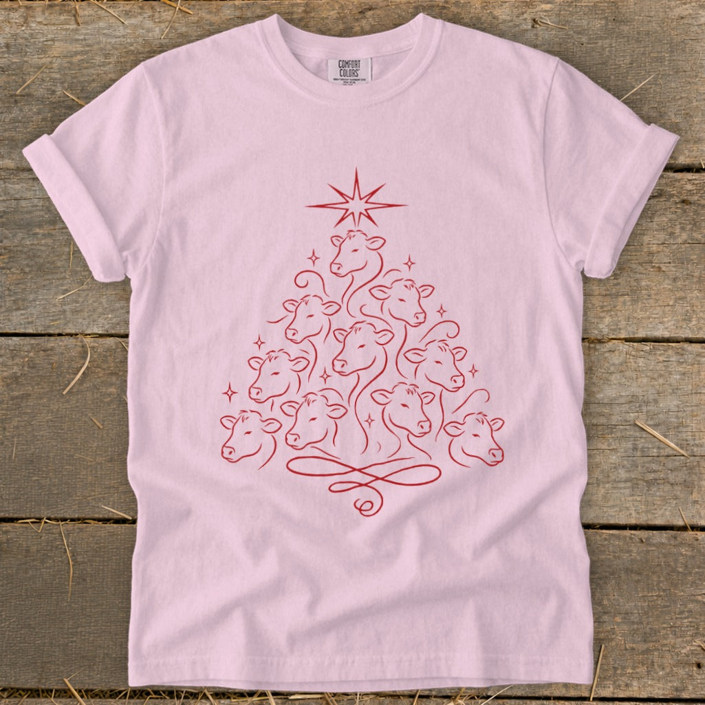Pink t-shirt with a red line art Christmas tree made of cow heads.