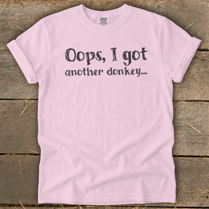 Pink t-shirt with "Oops, I got another donkey..." text.