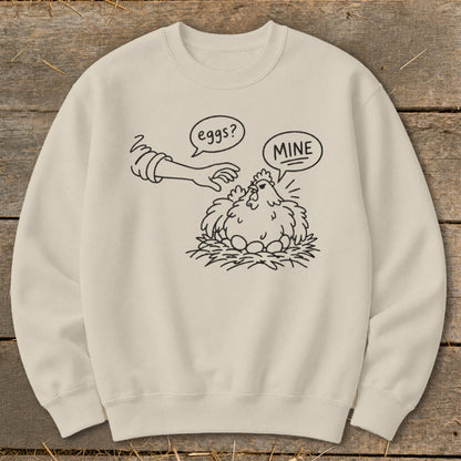 Cream sweatshirt with line drawing of chicken guarding eggs, saying "MINE".