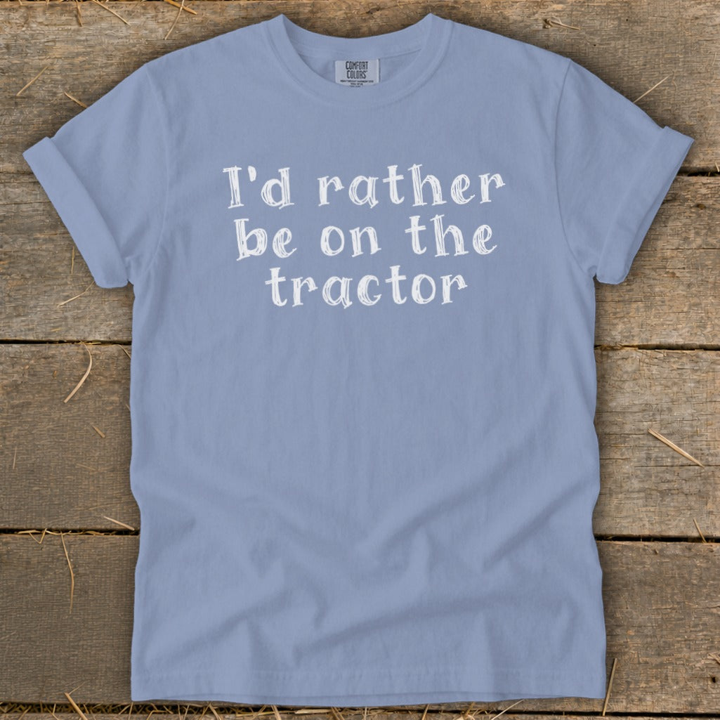 Light blue t-shirt with white text "I'd rather be on the tractor".