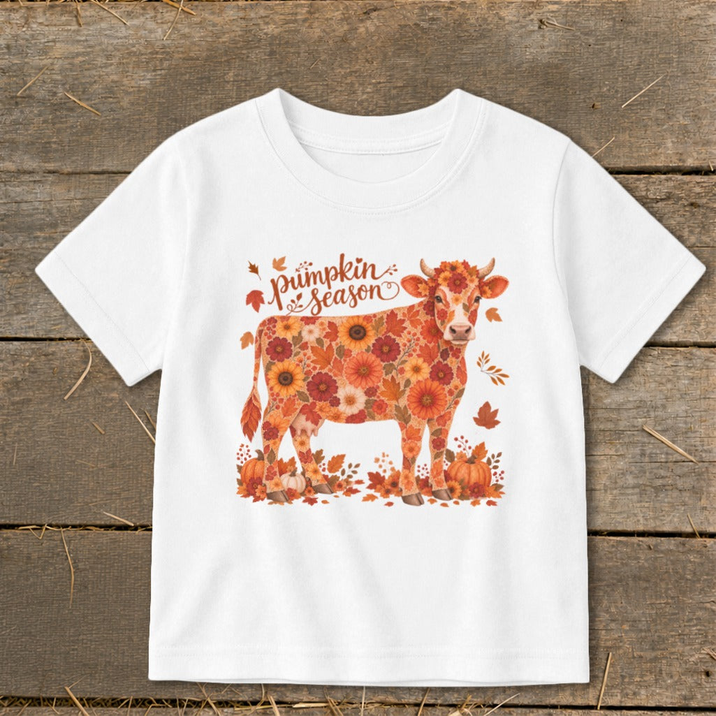 White t-shirt with a cow made of fall flowers and text reading "pumpkin season".