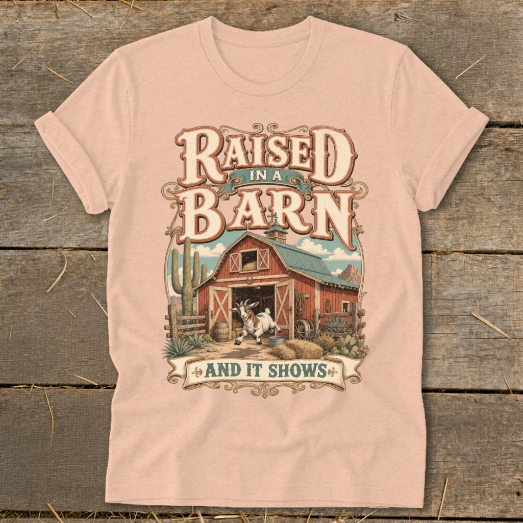 T-shirt graphic with text "Raised in a Barn and It Shows" and a barn scene.