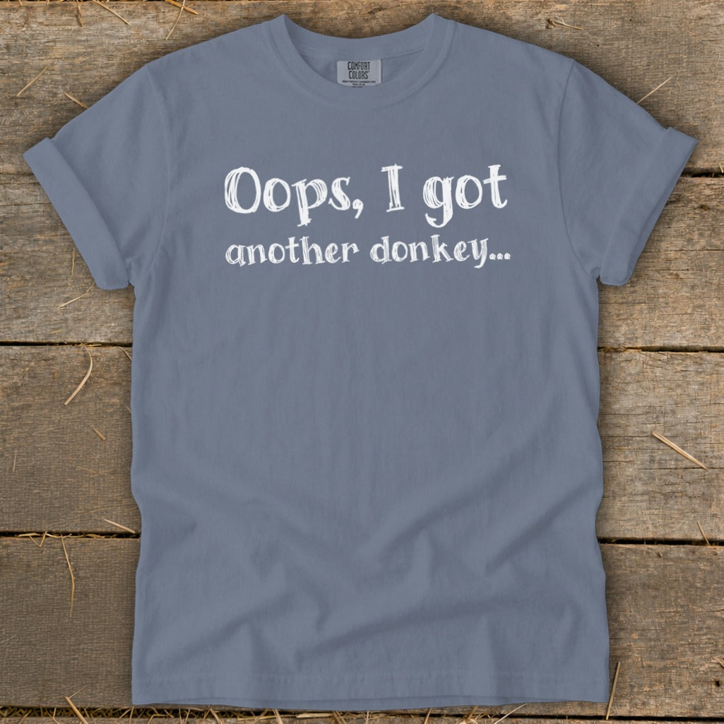 Blue t-shirt with white text "Oops, I got another donkey..."