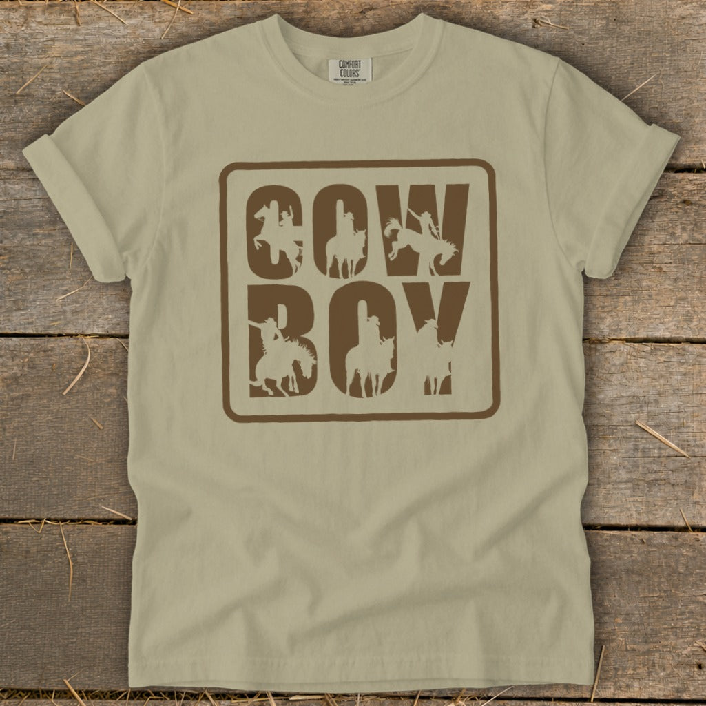 Tan t-shirt with brown "COW BOY" text and cowboy silhouettes within each letter.