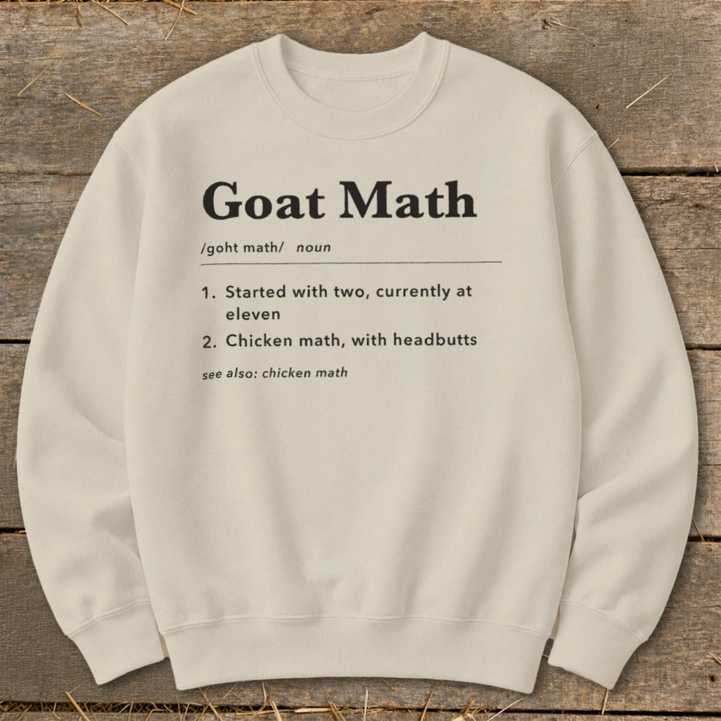 Cream sweatshirt with "Goat Math" definition, humorously describing goat behavior.