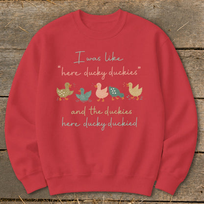 Red sweatshirt with "I was like 'here ducky duckies' and the duckies here ducky duckied" and ducks.