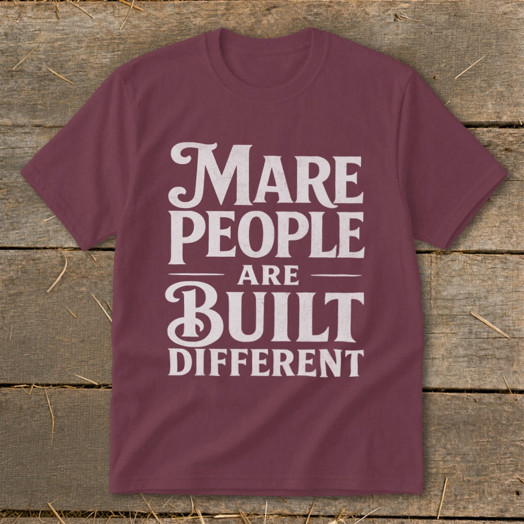 Maroon t-shirt with white text that reads "Mare People Are Built Different".