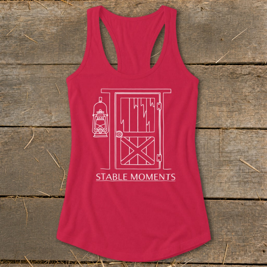 Red tank top with white outline of barn door, lantern, and text "STABLE MOMENTS".