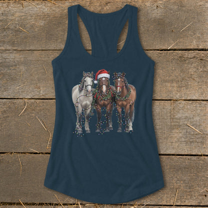 Three horses, one wearing a Santa hat, are decorated with Christmas lights.