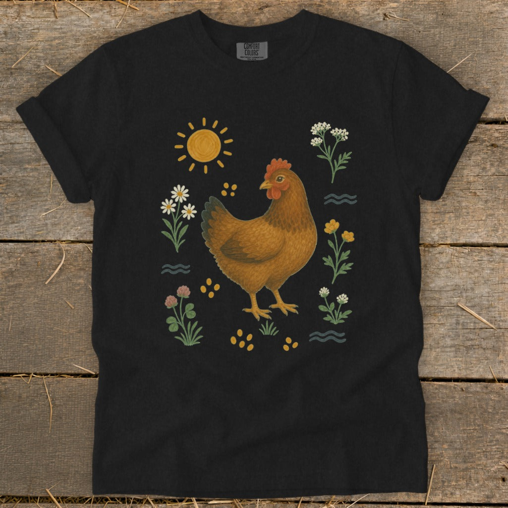 Black t-shirt with a brown chicken surrounded by flowers, sun, and wavy lines.