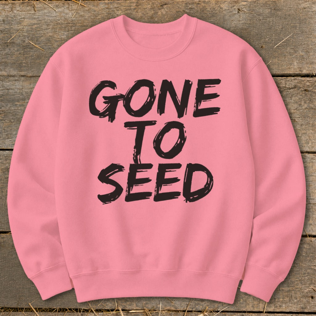 Pink crewneck sweatshirt with black distressed text reading "GONE TO SEED".