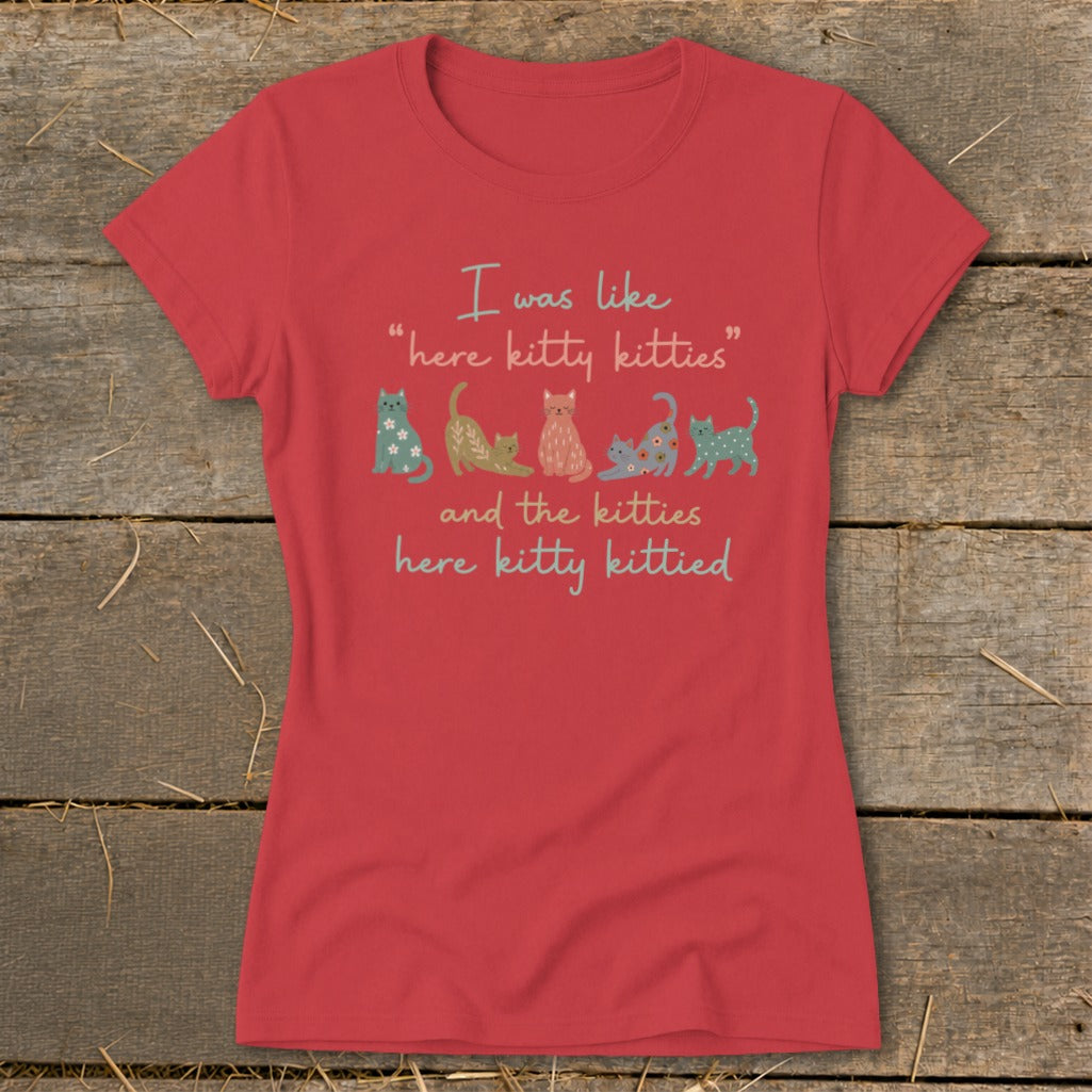 Red t-shirt with text "I was like 'here kitty kitties' and the kitties here kitty kittied" and cat illustrations.