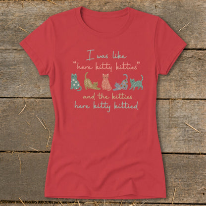 Red t-shirt with text "I was like 'here kitty kitties' and the kitties here kitty kittied" and cat illustrations.