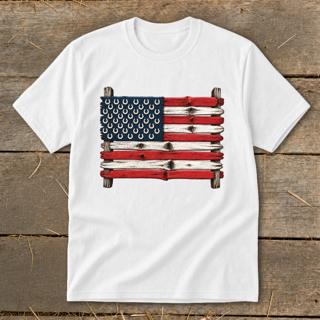 A white t-shirt featuring a graphic of the American flag made from weathered wood planks and horseshoes.