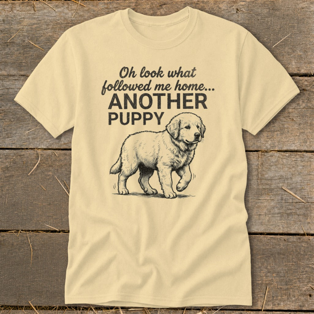 Light yellow t-shirt with text "Oh look what followed me home... ANOTHER PUPPY" and puppy illustration.