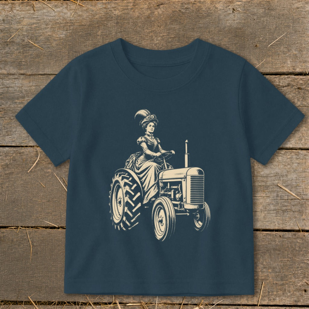 Vintage illustration of woman in hat driving a tractor, printed on navy blue t-shirt.