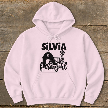 Pink hoodie with "Silvia farmgirl" text and farm graphic.