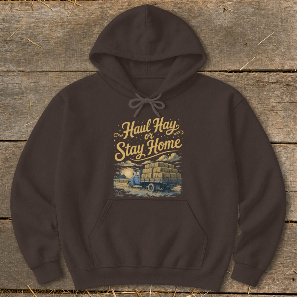 Brown hoodie with "Haul Hay or Stay Home" text and hay truck illustration.