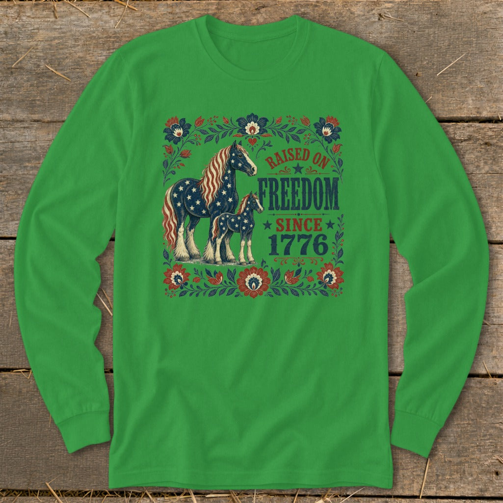 Green long-sleeve shirt with a patriotic horse design and "Raised on Freedom Since 1776" text.