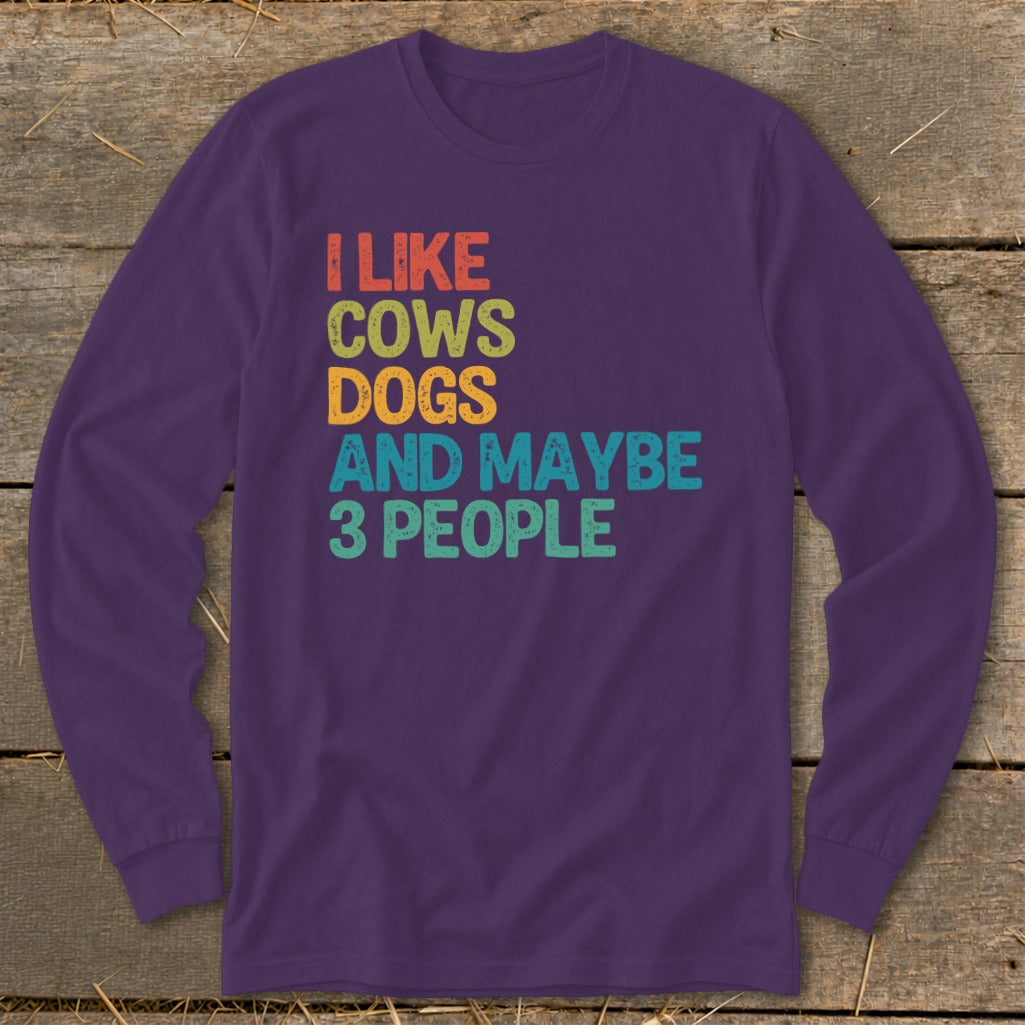 Purple long-sleeve shirt with text "I like cows dogs and maybe 3 people".
