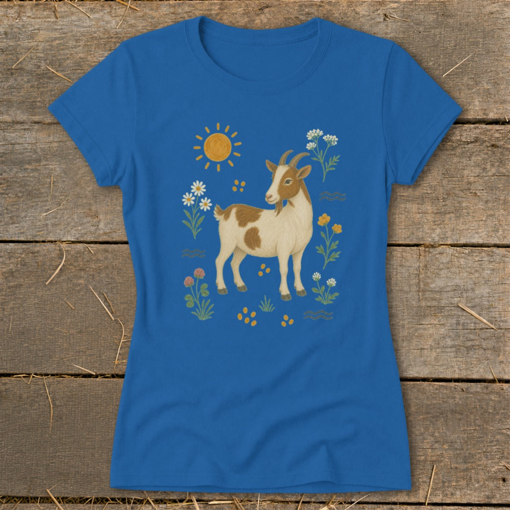 Blue t-shirt with illustration of a brown and white goat among flowers and sun.