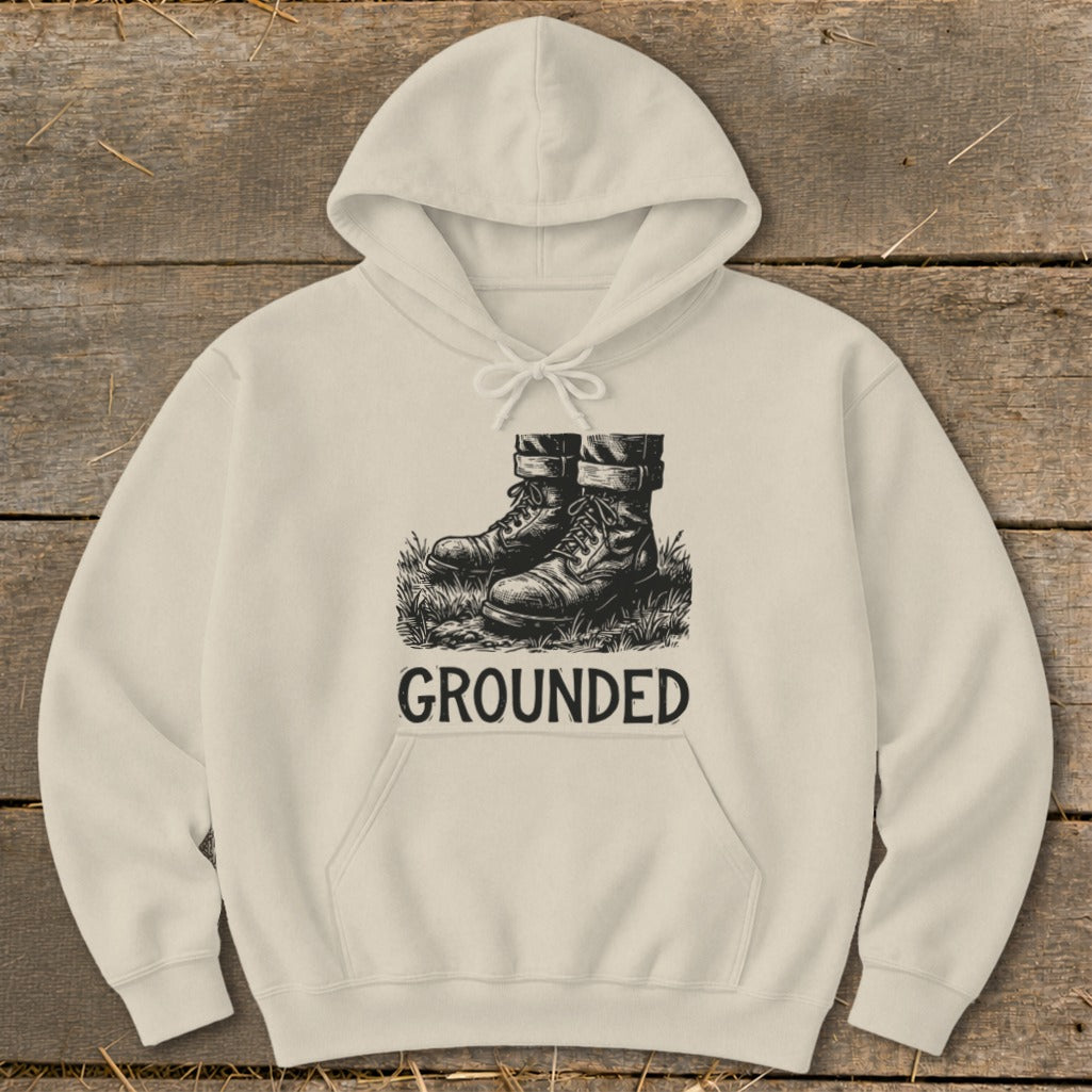 Cream hoodie with black graphic of boots and the word "GROUNDED"