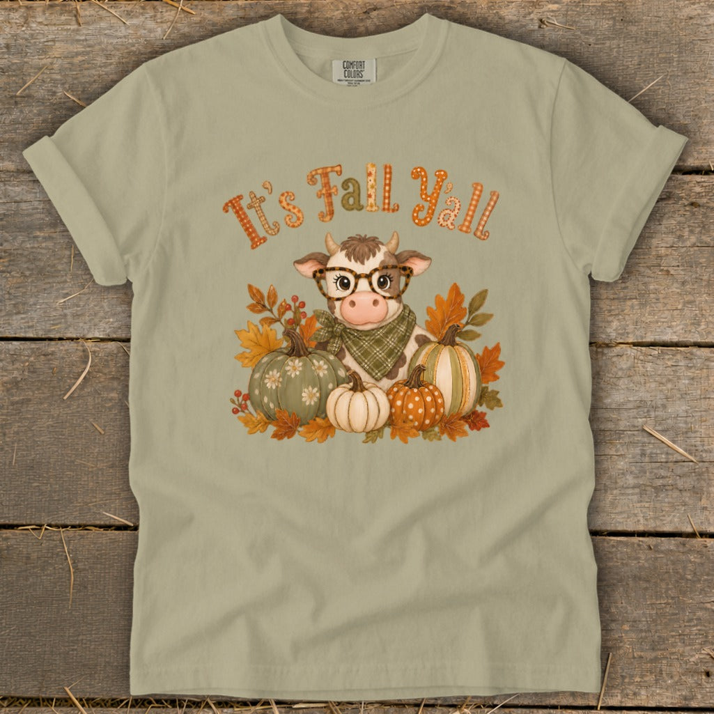 Cow with glasses and scarf surrounded by pumpkins and fall leaves, says "It's Fall Y'all."