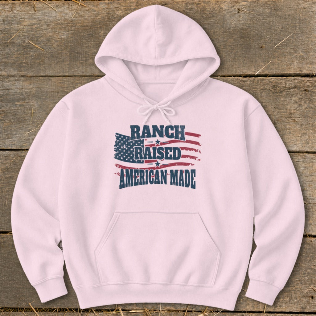 Pink hoodie with American flag graphic and text "RANCH RAISED AMERICAN MADE".