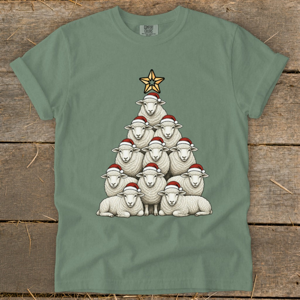 Green t-shirt with sheep arranged as a Christmas tree wearing Santa hats.