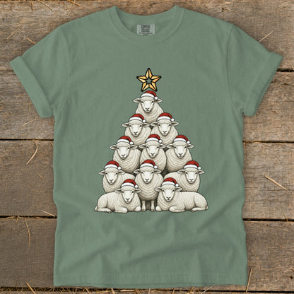 Green t-shirt with sheep arranged as a Christmas tree wearing Santa hats.
