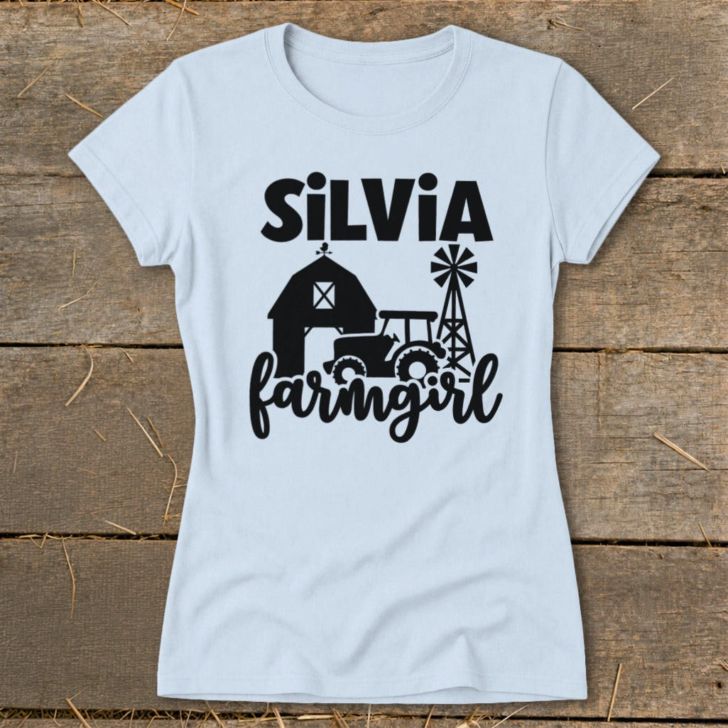 Light blue t-shirt with black "SiLVia farmgirl" text, barn, tractor, and windmill graphic.