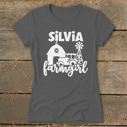 Dark grey t-shirt with white text "SILVIA" and farm scene graphic.