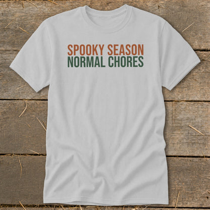 Light gray t-shirt with "SPOOKY SEASON" in orange and "NORMAL CHORES" in green.