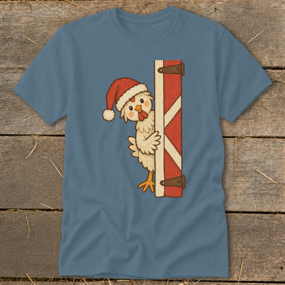 Chicken wearing Santa hat peeking from behind a red barn door.